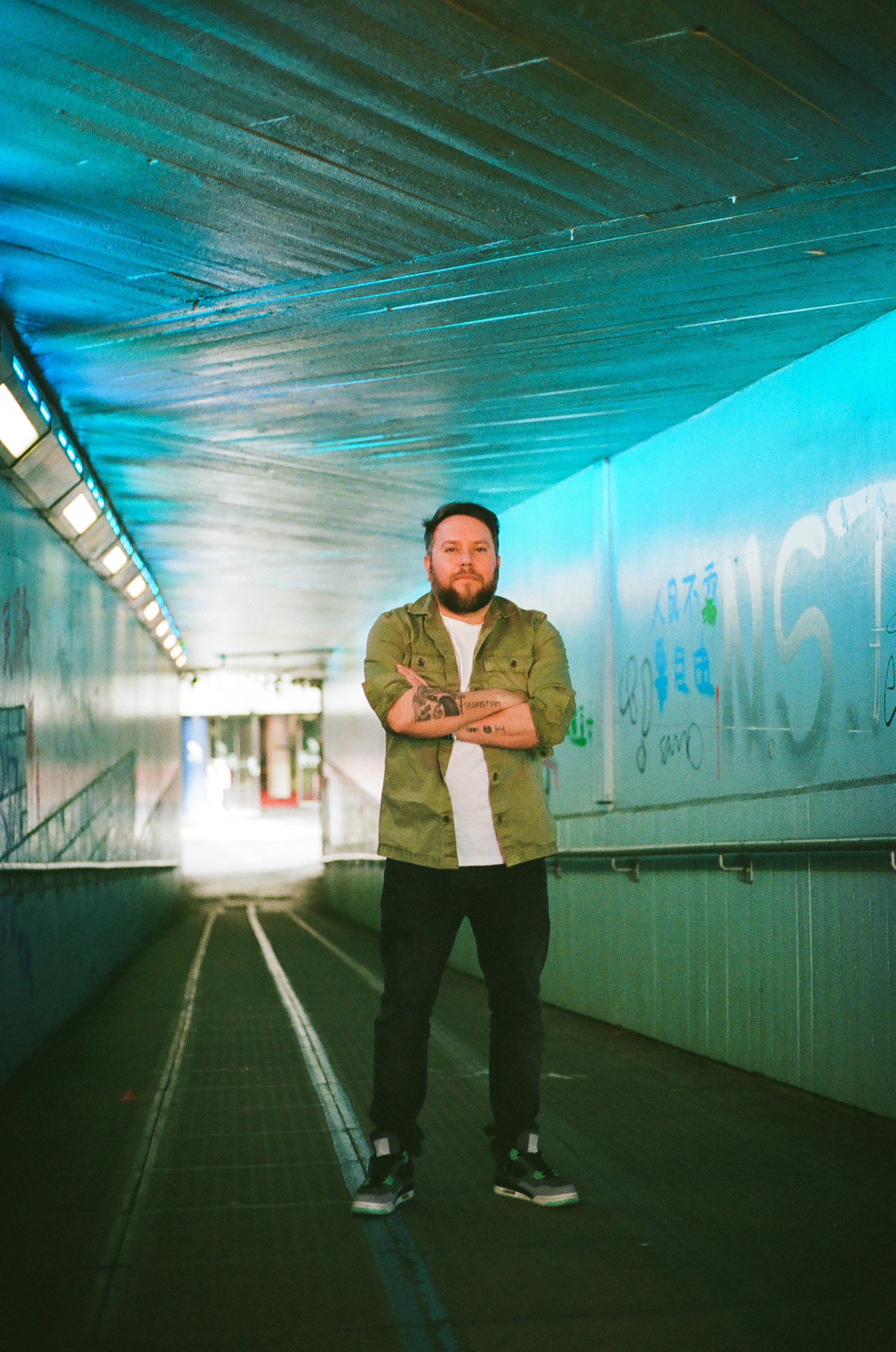 WEISS photographed in a blue-lit passage